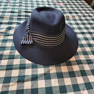 Vintage women's navy blue straw Panama hat with blue and white striped Ribbon